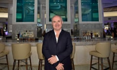 Damien Hirst smiling in front of the shark sculpture during a party at the Palms casino resort in Las Vegas