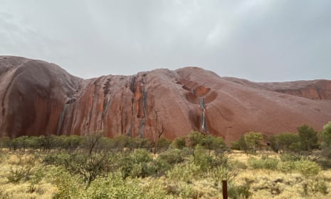 Uluru waterfalls come to life after heavy rainfall in central Australia – video