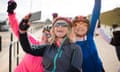 Group of female cyclists taking a selfie while sitting on their bikes.