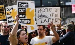 journalists holding up signs saying 'protect the future of the LA times"