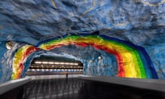A painted rainbow arcs over a girl on the platform of Stadion metro station on the Stockholm T-Bana in Sweden.