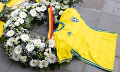 A Sweden team shirt and flowers next to a banner reading 'Courage to the Swedish people' during a commemoration for the two fans who were killed by a gunman in a terrorist attack in Brussels in October