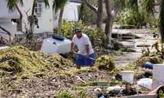 (FILES) This file photo taken on September 12, 2017 shows Iliat Martin shoveling seagrass from the entrance of his mobile home in the wake of hurricane Irma at Tavenier Key, Florida. US payrolls contracted in September for the first time in seven years as major hurricanes left workers idled in southern states but unemployment continued to fall, official data showed on October 6, 2017. Total non-farm employment fell by 33,000 net positions for the month, with a steep drop-off in hiring at restaurants and bars, according to the Labor Department. But the unemployment rate fell another two tenths to 4.2 percent, its lowest level since February of 2001. / AFP PHOTO / Gaston De CardenasGASTON DE CARDENAS/AFP/Getty Images