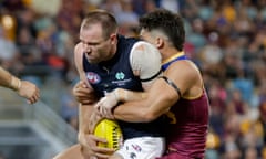 Sam Docherty is tackled by Cam Rayner during the 2024 AFL Opening Round match between Brisbane and Carlton