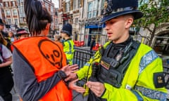 A police officer arrests a Just Stop Oil activist in Bishopsgate, London, in July.