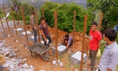 Construction workers helping to build emergency latrines in Nepal.