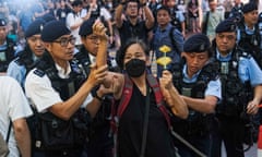 Chan Po-ying, an activist and leader of League of Social Democrats, is detained by police officers at Causeway Bay near Victoria Park.