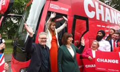 Keir Starmer, Angela Rayner and Rachel Reeves standing by a red bus with the word 'change 'on the side