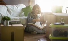 Woman looking at a photo album remembering old times