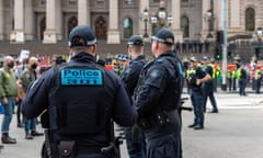 Police keep protesters and counter-protesters separate during an anti-trans rights protest outside Victorian parliament on Saturday