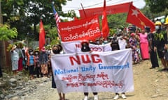 Protesters marching with banners supporting the opposition National Unity Government. 