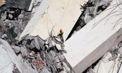 Rescue workers search on the site of the collapsed Morandi bridge