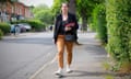 Jess Phillips, holding Labour campaign leaflets, walking down a residential street