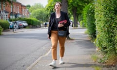 Jess Phillips, holding Labour campaign leaflets, walking down a residential street