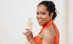 Regina King in an orange dress.