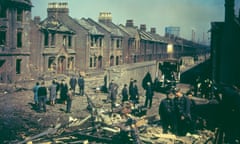 Residents inspect bomb damage to houses in London during the blitz.