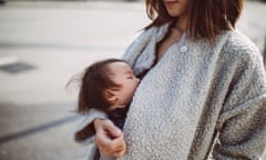 Mother carrying baby near chest