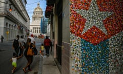 cuban flag on a building with a grand domed building in the background