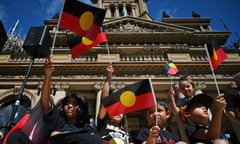 Children wave the Aboriginal flag at an Invasion Day demonstration in Sydney on 26 January 2022.