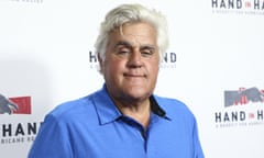 Jay Leno wearing a blue shirt posing for the cameras at an event
