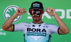 Peter Sagan celebrates his race win on the podium, before receiving the green jersey for the race’s leading sprinter.