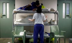 Women chat as they lie in beds placed in the communal area outside cells, due to overcrowding at the Los Angeles County Women's jail in Lynwood, California.