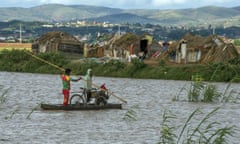 People cross flooded fields after a cyclone in Madagascar