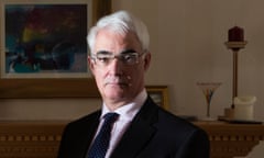 Alistair Darling poses for a photo in front of a mantelpiece