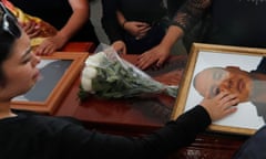 Relatives touch the coffin and photo of police officer Pablo Sergio Reynel, one of a group of officers killed in the line of duty, during a memorial service at the public security department headquarters for Michoacan, in Morelia, Mexico, Tuesday, Oct. 15, 2019. More than 30 suspected cartel gunmen ambushed the police officers in the town of El Aguaje on Monday as they were traveling in a convoy to serve a warrant, killing 13 officers and wounding nine others. (AP Photo/Marco Ugarte)
