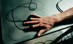 Person’s hand hooked up to polygraph test, lie detector close-up (Overhead view)