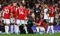 The Manchester United defender Harry Maguire receives treatment on the pitch during the Premier League match against Fulham.