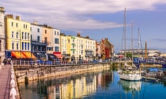 RAMSGATE, ENGLAND - MAY 9 2019 The bright colourful buildings, cafes and restaurants along the quayside of the impressive historic Royal Harbour with the Royal Pavilion and Obelisk in the background.; Shutterstock ID 1393193987; purchase_order: -; job: -; client: -; other: -