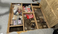 A trap door leans open over narcotics, including fentanyl, and drug paraphernalia stored in the floor of a daycare center.