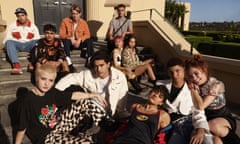 A promo photo of the cast of Heartbreak High, the cast members are sitting on a set of stairs, some of them are leaning on each other