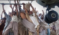 Marooned flood victims, including Mohammed Farhan and Allah Dita, look to escape by grabbing on to the side bars of an army helicopter. One year later Farhan and Dita pose with residents from the same village in the same location. ‘All I was thinking was to save my life. To get out,’ said Dita.