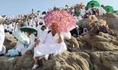 Muslim pilgrims use umbrellas to protect themselves from the heat as they gather on Mount Arafat during the 2023 Hajj pilgrimage
