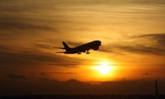 plane taking off at sunset