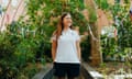 Jess Thom in sports gear under an arch with green leaves and bunting