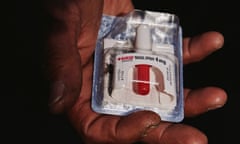 A person holds a packaged NARCAN naloxone nasal spray