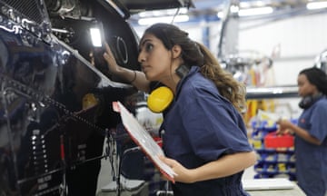 Young female engineers working with helicopters