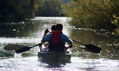 People paddling a canoe on a river