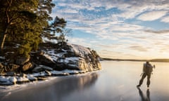 A man ice-skating on a frozen lake in in Östergötland, Sweden.