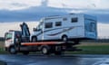 A motorhome on the back of a recovery truck