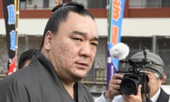 The Mongolian sumo grand champion Harumafuji leaves after visiting wrestler Takanoiwa’s stable master’s quarters in Tagawa, south-western Japan, earlier this week.