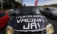 Protesters drive their car with a sign reading in Portuguese “Copa No, Vaccines Now” to protest the holding of Copa America in Brasilia, Brazil, Sunday, June 6, 2021. Brazil accepted hosting the South American soccer tournament after the original co-hosts were dropped: Colombia due to political protests and Argentina for rising of COVID-19 cases. (AP Photo/Eraldo Peres)