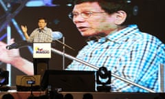 Rodrigo Duterte raises his hand during his speech