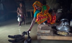 Photographer Captures Life For Families In Flood-Hit Bangladesh<br>KURIGRAM, BANGLADESH - SEPTEMBER 07: A woman feeds hens in her house on September 7, 2015, in Kurigram District, Bangladesh. 

Incredible photos show the resilience of Bangladeshi families whose homes have been engulfed by flood waters. Young boys paddle through the streets on rafts, and a woman wades through waist-high water to collect some for her family to drink. In another photo children sit on a building's roof poking just above the surface. People living on small islands in the country's Kurigam District have lost their homes after heavy floods hit for the second time in four weeks.

PHOTOGRAPH BY Zakir Hossain Chowdhury / Barcroft Media

UK Office, London.
T +44 845 370 2233
W www.barcroftmedia.com

USA Office, New York City.
T +1 212 796 2458
W www.barcroftusa.com

Indian Office, Delhi.
T +91 11 4053 2429
W www.barcroftindia.com