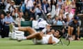 Carlos Alcaraz falls to the ground in disbelief after winning match point against Novak Djokovic.