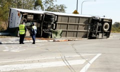 The scene of the Singleton bus crash with the bus lying on its side