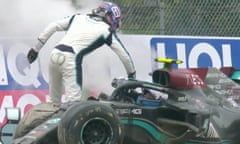 George Russell (standing) and Valtteri Bottas in the wake of the crash on Sunday.